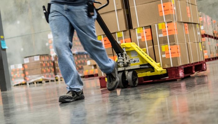 Employee pulling boxes in warehouse